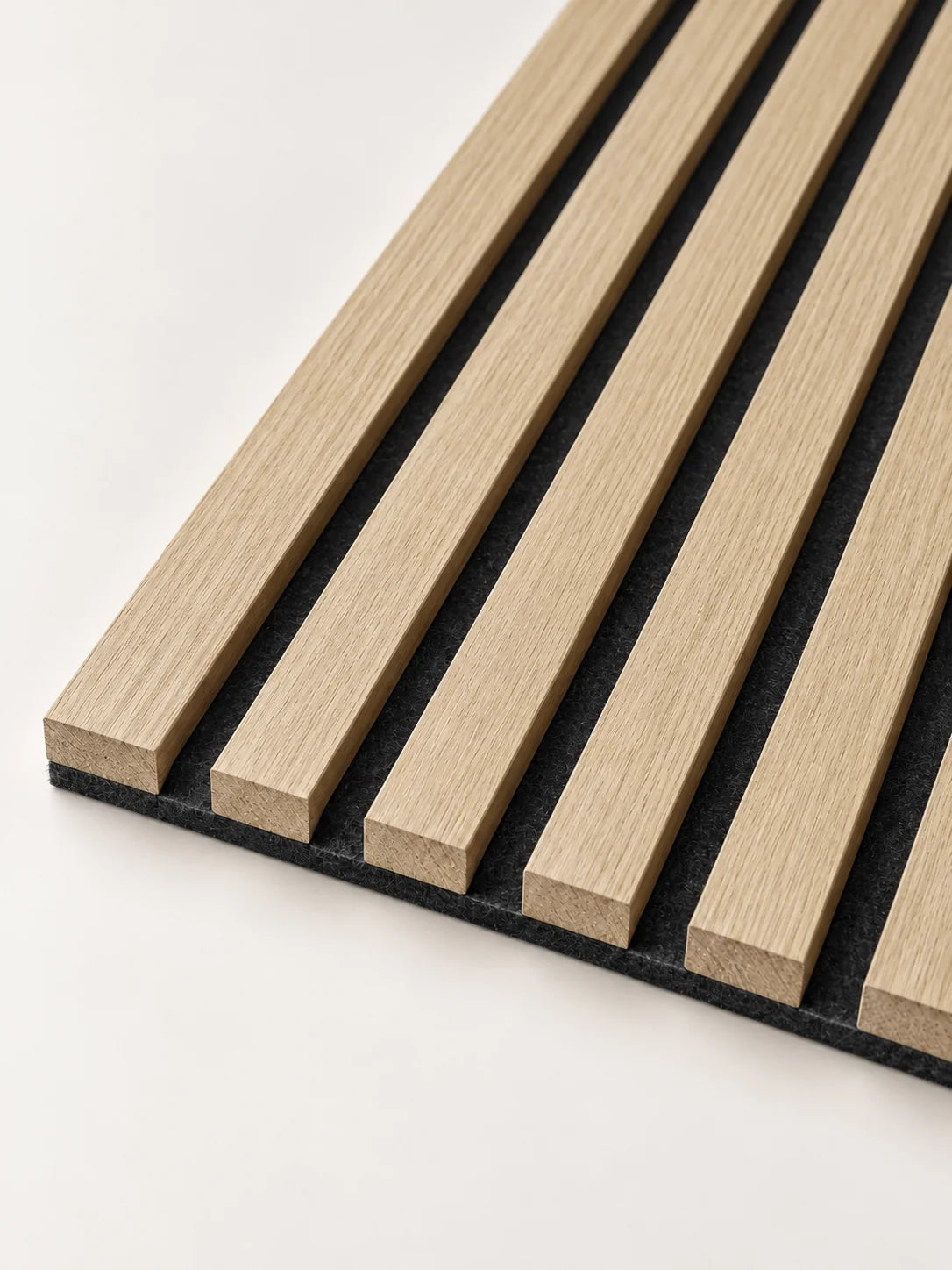 Close-up of light oak timber slats and the dark felt backing beneath them.